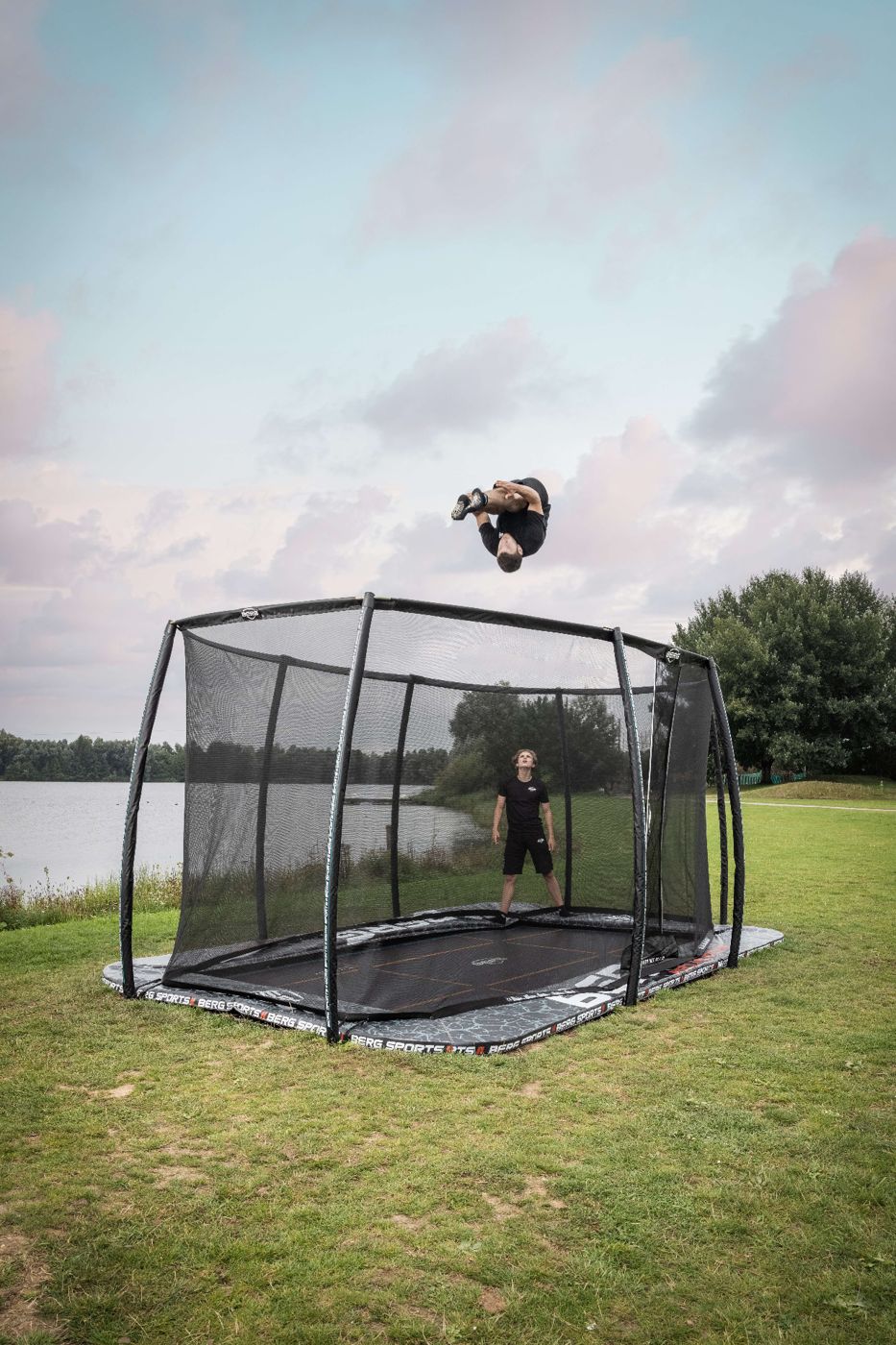 BERG FlatGround Pro Bouncer trampoline with a safety net in a garden
